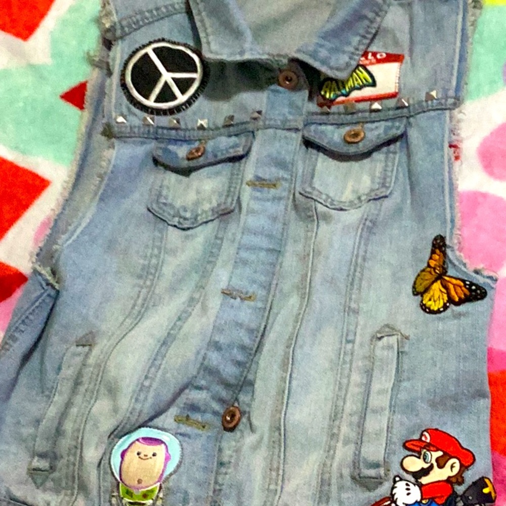 Jean jacket turned into a vest. Patches added by me!!!!